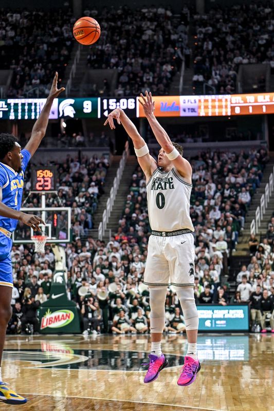 Michigan State's Jaxon Kohler, right, makes a 3-pointer against UCLA's Xavier Booker during the first half on Tuesday, Feb. 17, 2026, at the Breslin Center in East Lansing.