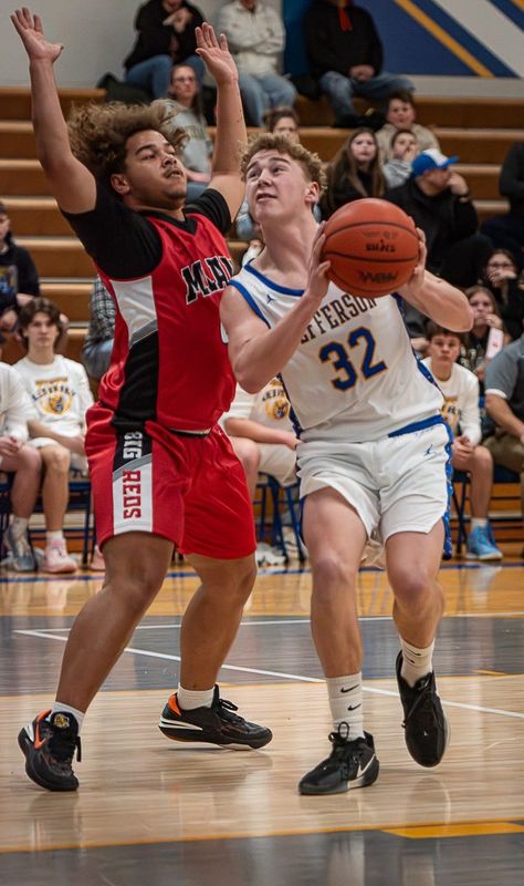 Jefferson's Trey Oldenburg goes to the basket against Elijah Blackmon of Milan during a 67-46 Jefferson victory on Tuesday, Feb. 17, 2026.