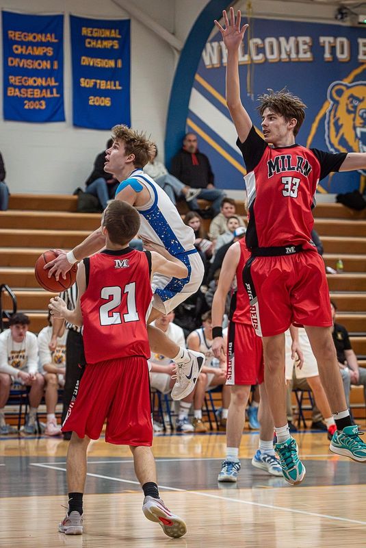 Jefferson's Luke Beaudrie drives against Jayden Lasyone (21) and Henry Kliber of Milan during a 67-46 Jefferson victory on Tuesday, Feb. 17, 2026.