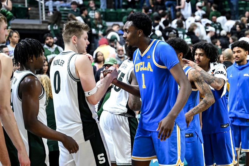 Michigan State's Jaxon Kohler, left, shakes hands with former teammate UCLA's Xavier Booker after the game on Tuesday, Feb. 17, 2026, at the Breslin Center in East Lansing.