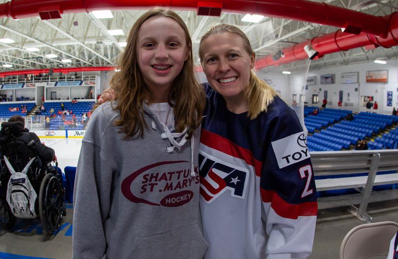 Plymouth's Kirsten Simms, left, poses with U.S. national team member Kendall Coyne Schofield at the 2017 women's world championships in Plymouth. Simms, now 21, was 12 years old when she met Coyne Schofield, who are now teammates heading into Thursday's gold-medal game against Canada at the Olympics.