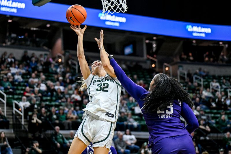 Michigan State's Marah Dykstra, left, scores and draws a foul from Northwestern's Tayla Thomas during the second quarter on Wednesday, Feb. 18, 2026, at the Breslin Center in East Lansing.