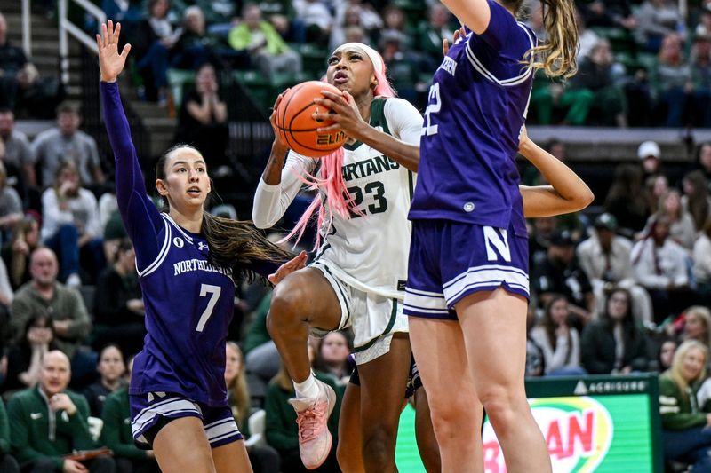Michigan State's Jalyn Brown, center, scores and draws a Northwestern foul during the fourth quarter on Wednesday, Feb. 18, 2026, at the Breslin Center in East Lansing.