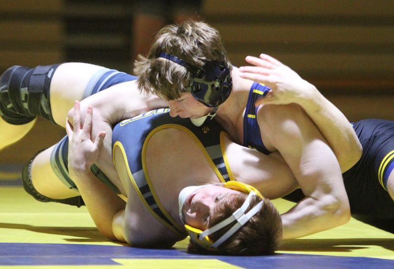 Hartland's Dallas Korponic (top) wrestles Clarkston's Etienne Mohr during a Division 1 team regional championship dual on Wednesday, Feb. 18, 2026.