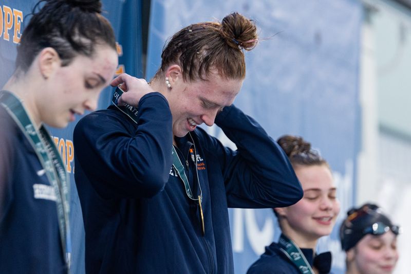 Hope's Greta K. Gidley smiles after winning the 200 yard IM on Thursday, Feb. 19, at the Holland Aquatic Center.