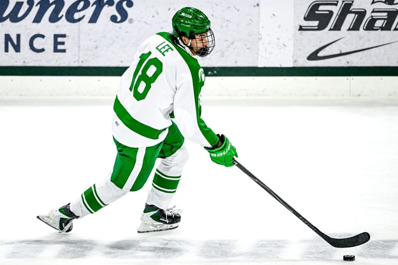 Michigan State's Ryker Lee moves the puck against Notre Dame during the first period on Thursday, Feb. 19, 2026, at the Munn Ice Arena in East Lansing.