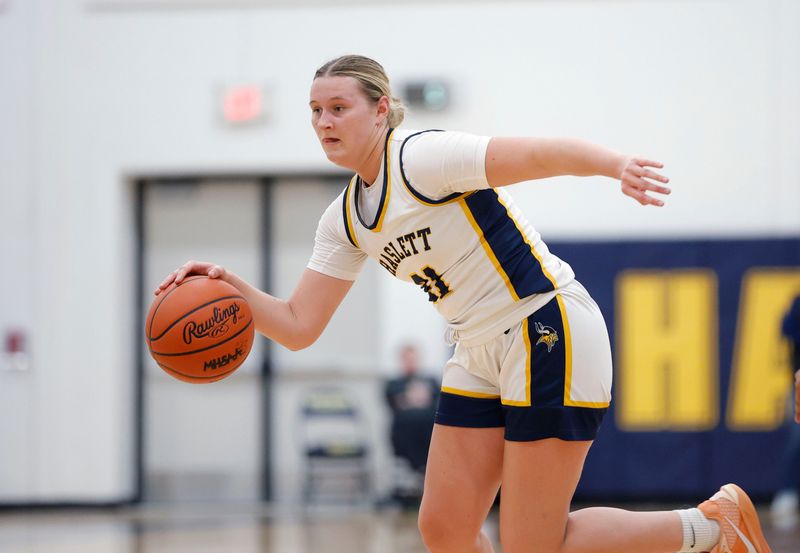 Haslett's Kaitlyn Johnson drives against Holt, Thursday, Feb. 19, 2026, in Haslett.