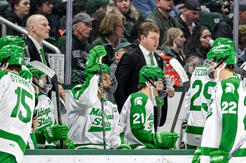 Michigan State's head coach Adam Nightingale, center, looks on during the third period in the game against Notre Dame on Thursday, Feb. 19, 2026, at the Munn Ice Arena in East Lansing.