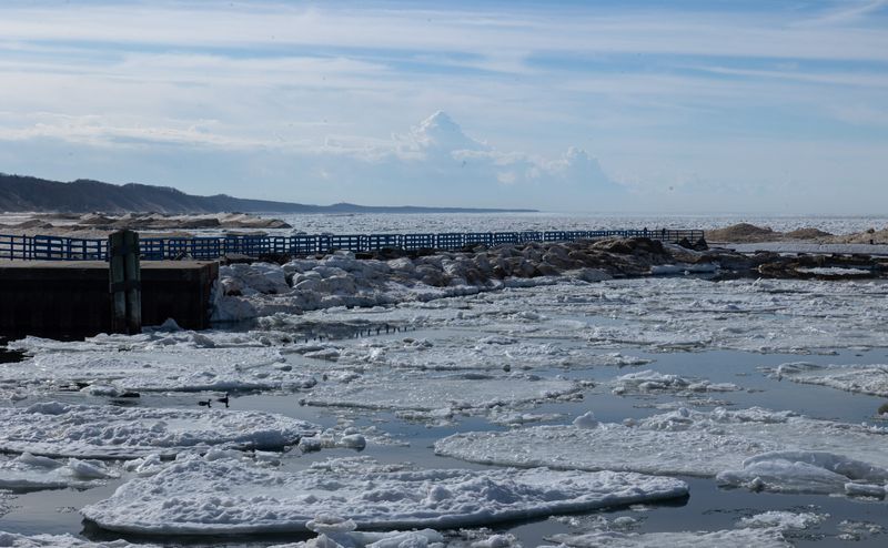 Clouds hang above the beach, stretching toward the horizon, on Thursday, Feb. 19, at Holland State Park.