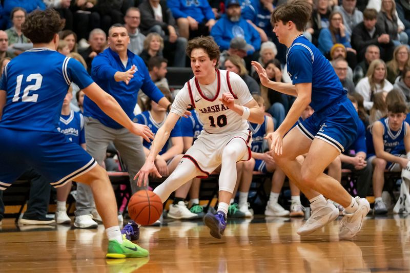Marshall senior Clark Erwin dribbles during a game against Harper Creek at Marshall High School on Friday, Feb. 20, 2026.
