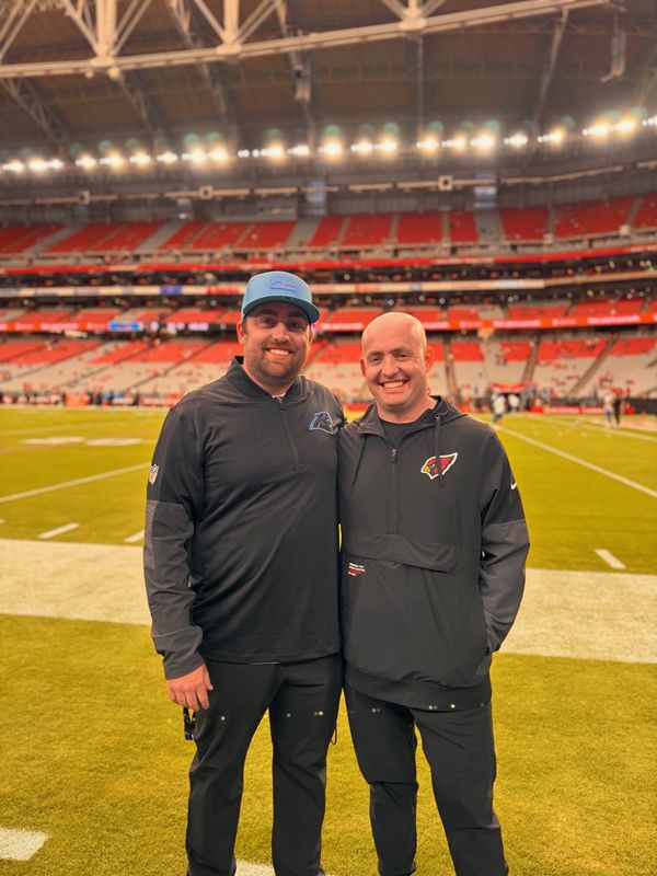New Lions offensive coordinator Drew Petzing, right, with brother Dean, an assistant coach with the Carolina Panthers.