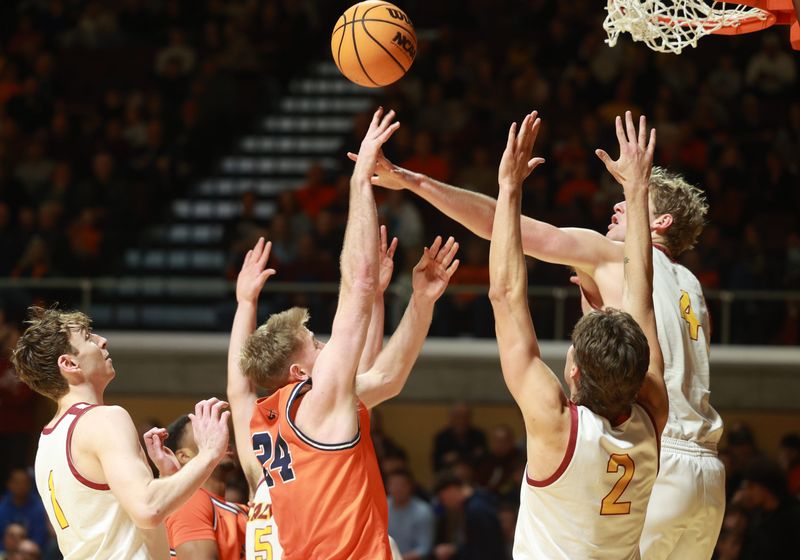 Calvin's Jalen Overway, right, blocks a shot by Hope's Parker Hovey on Saturday, Feb. 21, at Van Noord Arena.