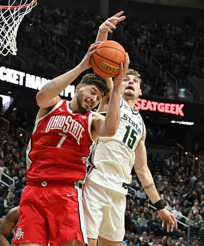 Ohio State’s Ivan Njegovan and Michigan State’s Carson Cooper work under the basket in the first half at the Breslin Center in East Lansing, Michigan on February 22, 2026.