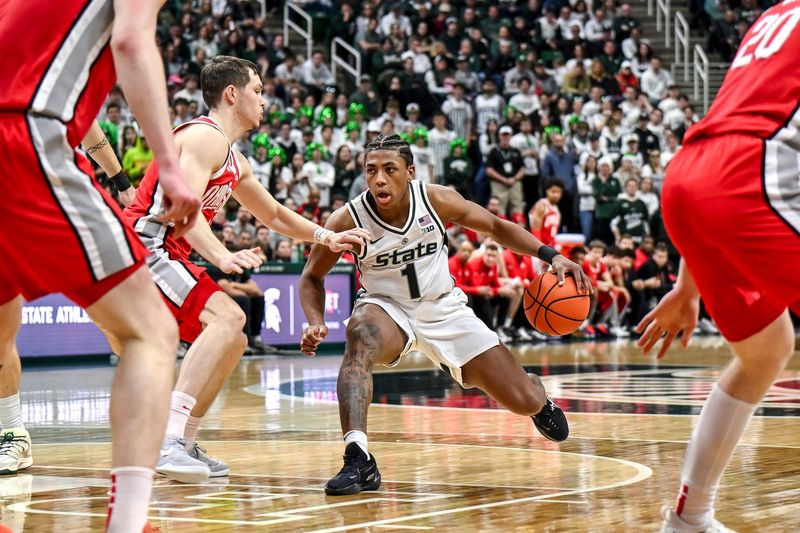 Michigan State's Jeremy Fears Jr., right, moves the ball against Ohio State's Gabe Cupps during the second half on Sunday, Feb. 22, 2026, at the Breslin Center in East Lansing.