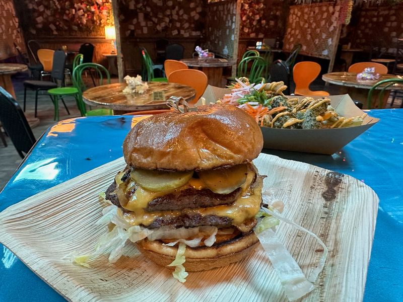 The Palace Burger from Calico Jack's has two smashed patties, American cheese, a house-made sauce, caramelized onions, shredded lettuce and pickles.