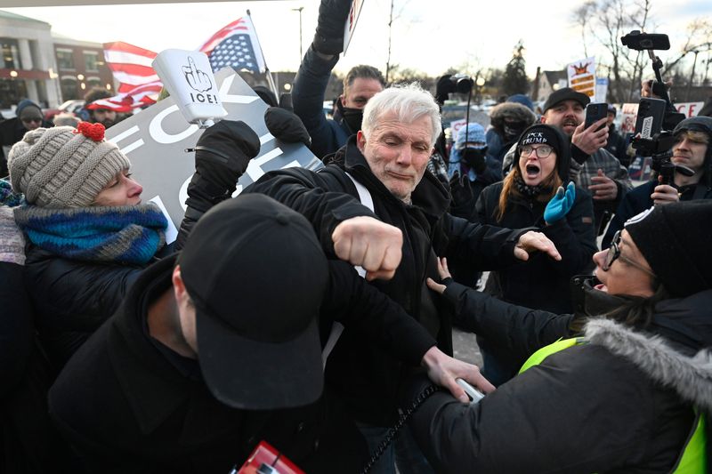 An unidentified protester, center, punches Jayden Scott, bottom left, outside Romulus City Hall. Scott was voicing his support for the detention center. The protester was upset with his point of view. Monday, February 23, 2026, in Romulus, Mich. Jose Juarez / Special to Detroit News