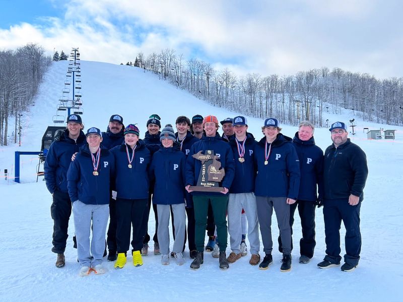The Petoskey boys ski team and coaches stand with their Division 2 state championship trophy at Schuss Mountain in Bellaire Monday, Feb. 23. It comes a year after a runner-up finish and gets the Northmen back on top in D2.