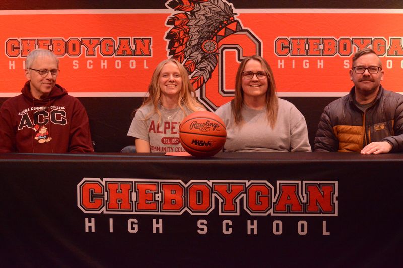 Alongside her parents and Alpena Community College women's basketball coach Karl Momrik, Cheboygan senior Addison Ptasnik signed to play for the Lumberjacks during a ceremony at her high school on Thursday, Feb. 19.