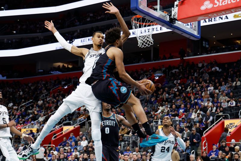 Detroit Pistons guard Cade Cunningham is fouled by San Antonio Spurs center Victor Wembanyama in the second half at Little Caesars Arena, Feb. 23, 2026.