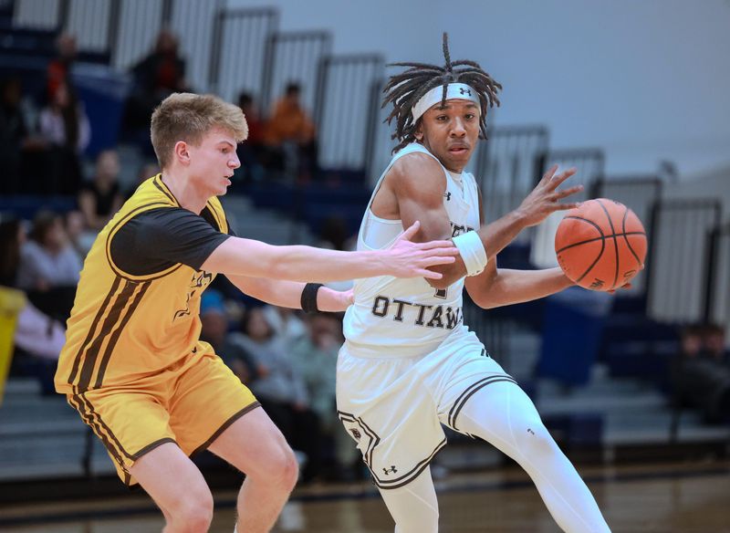 West Ottawa's JT Gill, right, drives against Zeeland East's Isaiah Boonstra on Wednesday, Feb. 25, at Grand Haven.