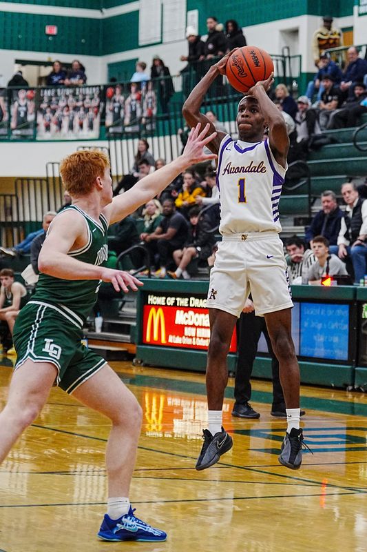 Auburn Hills Avondale’s Jaidon Bourgeois (1) shoots two over Lake Orion’s William Farmer (5) during the second half of the MHSAA semifinals at Lake Orion High School in Lake Orion, Mich, Wednesday, Feb. 25, 2026. Avondale defeated Lake Orion and will play Clarkston on Friday.