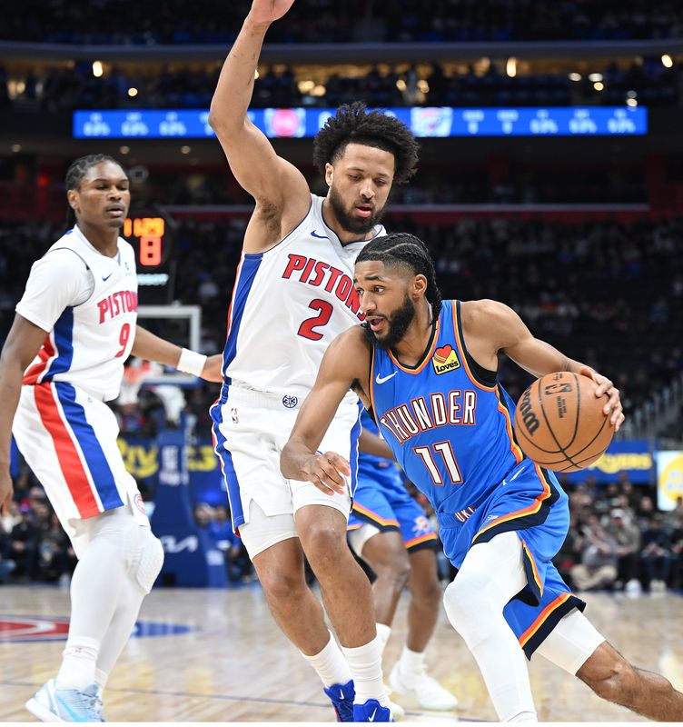 Oklahoma City Thunder guard Isaiah Joe (11) drives past Detroit Pistons guard Cade Cunningham (2) in the first half. Detroit Pistons vs Oklahoma City Thunder at Little Caesars Arena on February 25, 2026, in Detroit, MI.