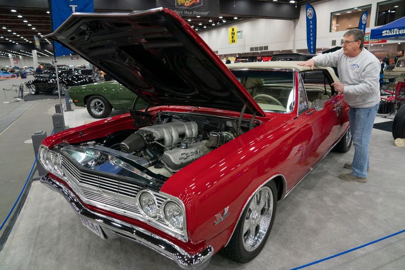 Ed Lynch of Davisburg smooths out the wrinkles in the soft top of his 1965 Chevelle during load-in day for the 73rd Annual Meguiar’s Detroit Autorama at Huntington Place on Thursday, Feb. 26, 2026.
