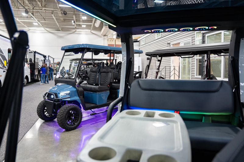 Golf carts on display during the Milwaukee Camper, Travel & RV Show in the Exposition Center at the Wisconsin State Fair Park on the afternoon of Feb. 26, 2026 in West Allis, Wisconsin.