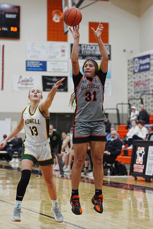 Belleville’s Sydney Savoury shoots a 3-pointer against Howell’s Gabrielle Piepho during the second half of MHSAA girls conference championships at Northville High School in Northville, Thursday, Feb. 26, 2026.