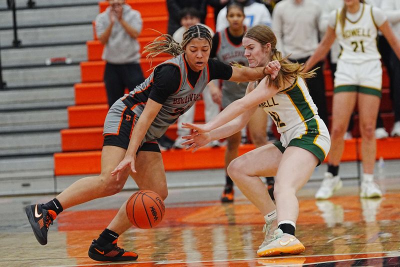 Belleville’s Sydney Savoury (31) gains control of the ball while defended by Howell’s Norah Hull (12) during the first half of the MHSAA girls conference championships at Northville High School, Thursday, Feb. 26, 2026.