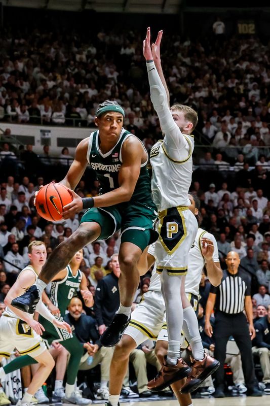 Braden Smith jumps to defend a shot from Michigan State's Jeremy Fears Jr. during the first half of Purdue's game against Michigan State on Feb. 26, 2026, at Mackey Arena in West Lafayette, IN.