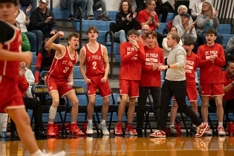 St. Philip players celebrate on the bench during a district playoff game at Climax-Scotts High School on Friday, Feb. 27, 2026.