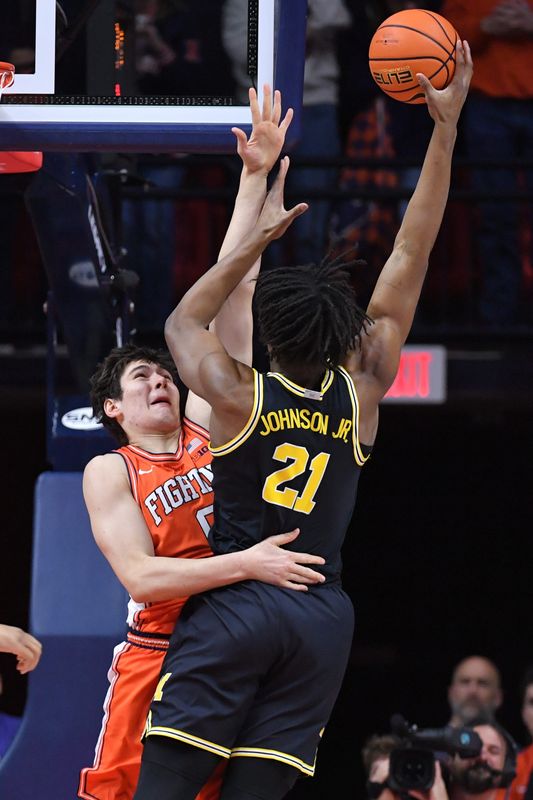 Michigan Wolverines forward Morez Johnson Jr. (21) drives the ball to the basket as Illinois Fighting Illini forward David Mirkovic (0) defends during the first half at State Farm Center in Champaign, Illinois, on Friday, Feb. 27, 2026.