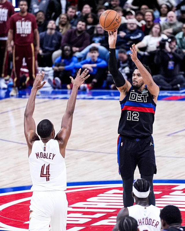 Detroit Pistons forward Tobias Harris (12) makes a jump shot against Cleveland Cavaliers center Evan Mobley (4) during the second half at Little Caesars Arena in Detroit on Friday, Feb. 27, 2026.