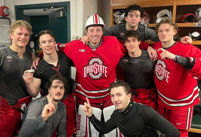 Ohio State goalie Kristoffer Eberly, center, celebrates with teammates after a 5-1 upset victory over the Spartans at Munn Ice Arena.