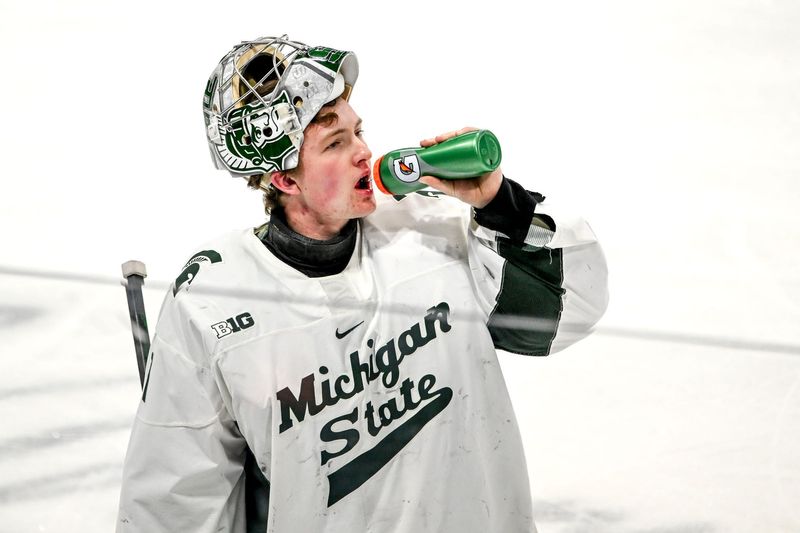 Michigan State's Trey Augustine takes a water break during a break in the action against Minnesota in the first period on Saturday, Jan. 25, 2025, at Munn Arena in East Lansing.