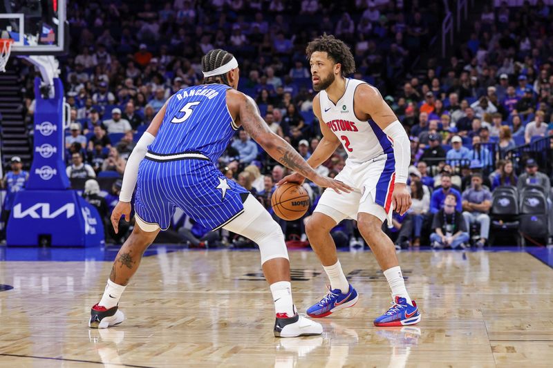 Detroit Pistons guard Cade Cunningham (2) handles the ball in front of Orlando Magic forward Paolo Banchero (5) during the first quarter at Kia Center in Orlando, Florida, on Sunday, March 1, 2026.