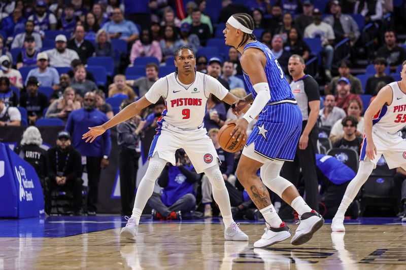 Detroit Pistons guard Ausar Thompson (9) defends Orlando Magic forward Paolo Banchero (5) during the first quarter at Kia Center in Orlando, Florida, on Sunday, March 1, 2026.