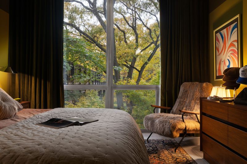 The views are just as dreamy from the main bedroom where the green walls, window treatments and ceiling speak to nature and incorporate the owner’s favorite color.