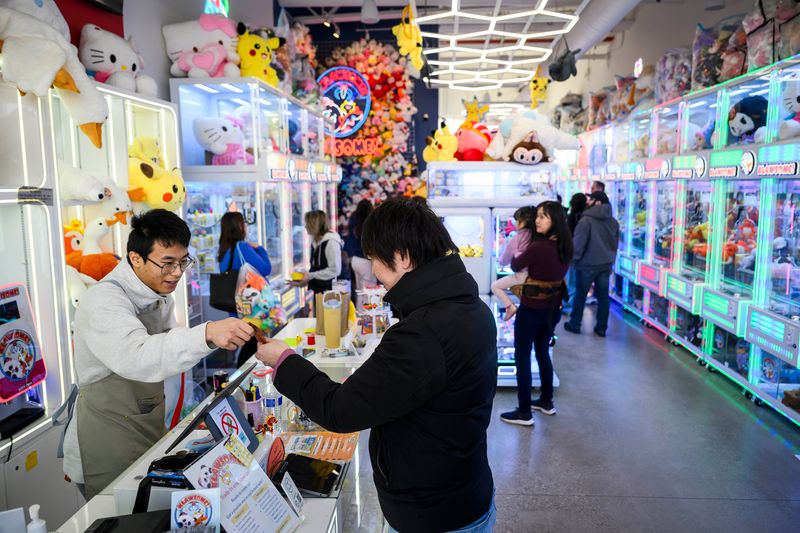 Visitors play with claw machines at Klawsome! at Sakura Novi, a new Asian-inspired mixed-use development in Novi, on Saturday, Feb. 28, 2026.