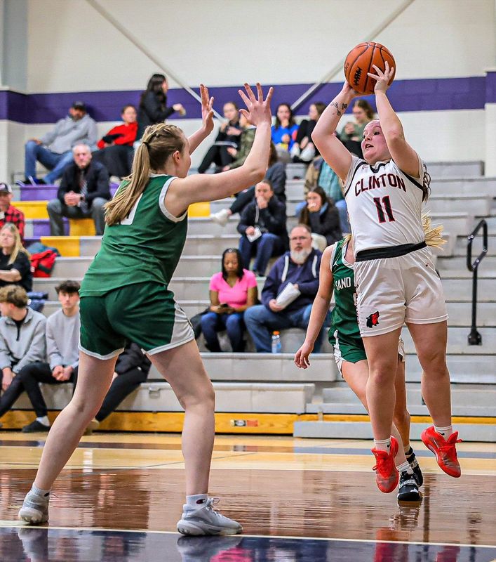 Clinton's Mickayla Whitehead (11) rises up for an opener jumper versus Sand Creek Monday night.