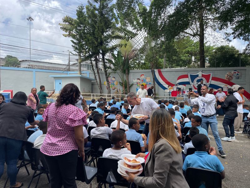 Detroit Tigers owner and CEO Christopher Ilitch hands out Little Caesars pizzas to kids in the Dominican Republic, Tuesday, March 3, 2026.
