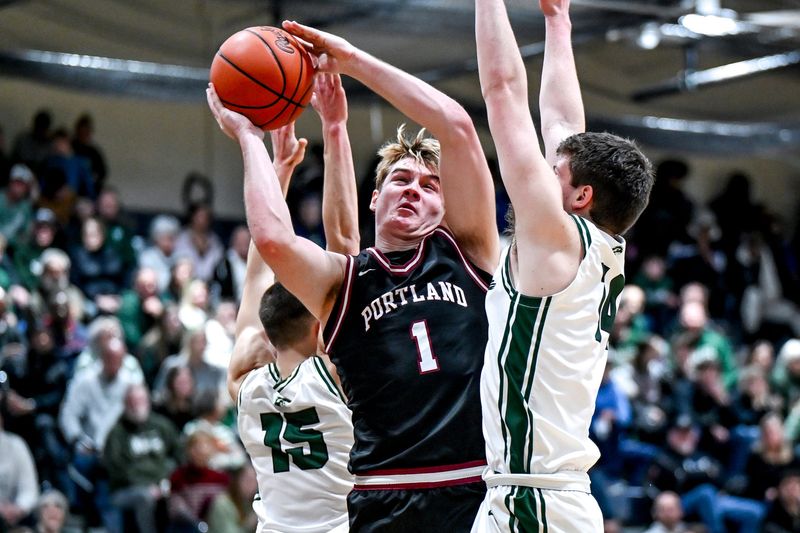 Portland's Carter White, left, shoots as Freeland's Wilson Huckeby defends during the second quarter on Tuesday, March 3, 2026, at Owosso High School.