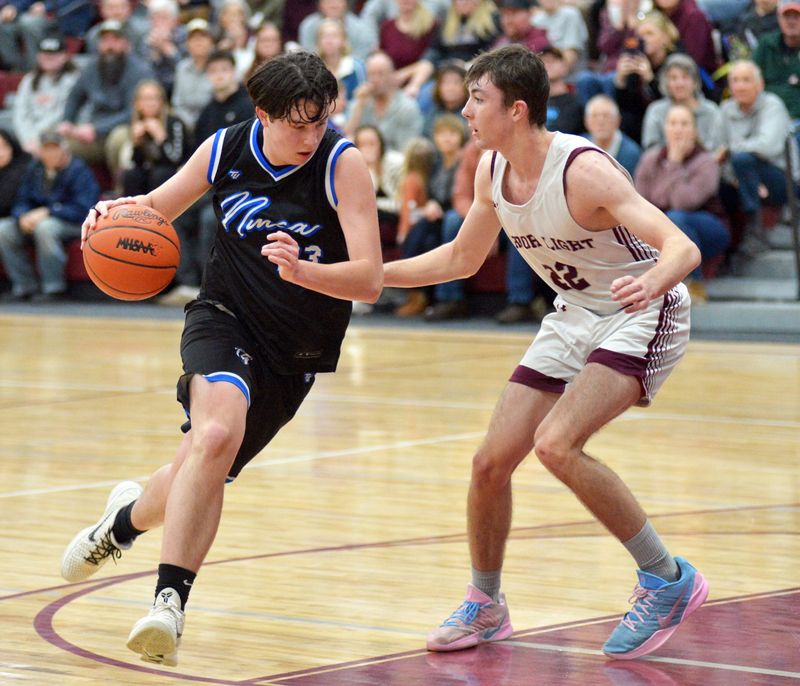 Sophomore Jeremiah Tucker (left) and the Burt Lake NMCA boys basketball team came back to win at Hillman in an MHSAA Division 4 boys basketball regional semifinal on Tuesday, March 3.