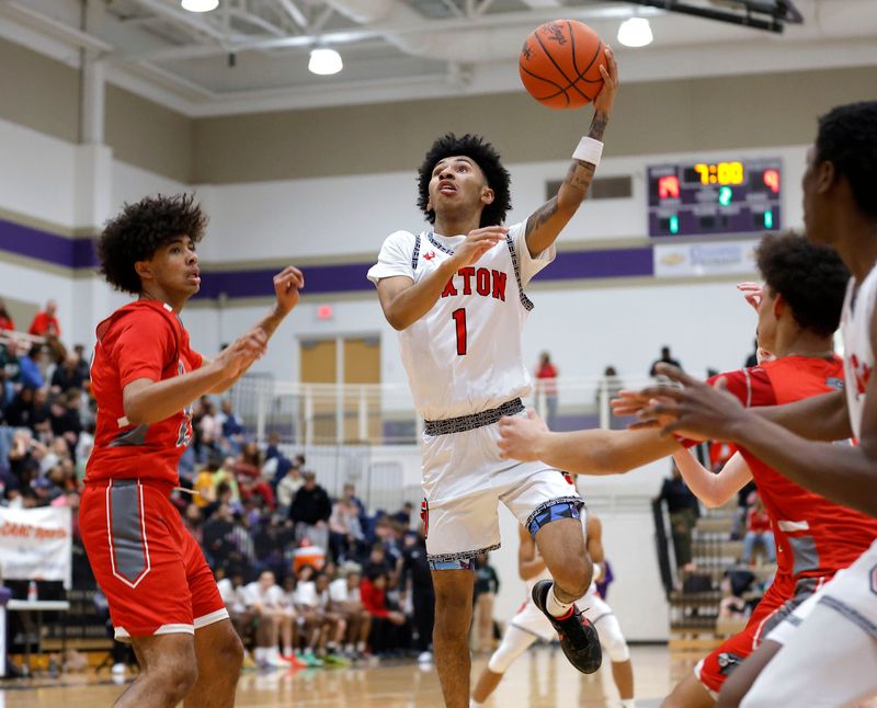 Lansing Sexton's Keyshawn Summerville shoots against Michigan Center's Jayden Watson, left, and Travis Collins, Tuesday, March 3, 2026, in Fowlerville.