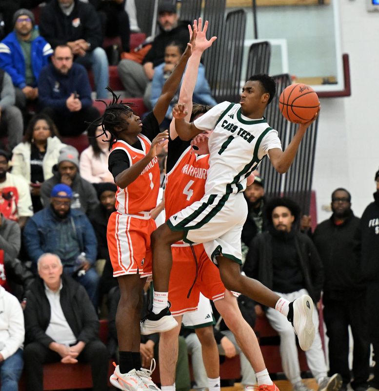 Brother Rice teammates Jordan McDaniel (1) and Ivan Stojanoviski (4) defend Cass Tech guard Steve Hall (1) in the first half as Detroit Cass Tech takes on Birmingham Brother Rice in boys basketball regional semifinals at Renaissance High School in Detroit on Mar. 3, 2026.