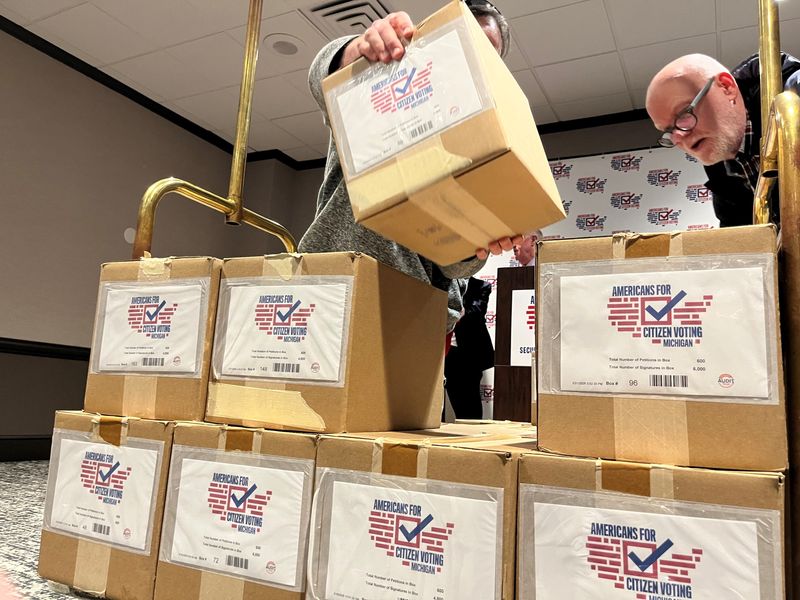 Volunteers for Americans for Citizen Voting stack boxes containing petition signature sheets for a proposed constitutional amendment that would require proof of citizenship in order to vote. The group said Wednesday, March 4, 2026, that it had collected more than 750,000 signatures in support of the ballot proposal.