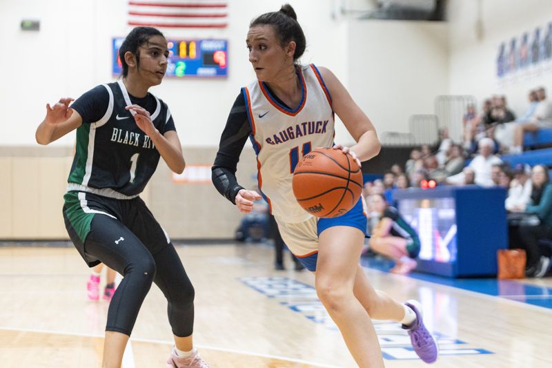 Saugatuck's Mylah Simpson, right, drives to the basket against Black River on Wednesday, March 4, at Saugatuck High School