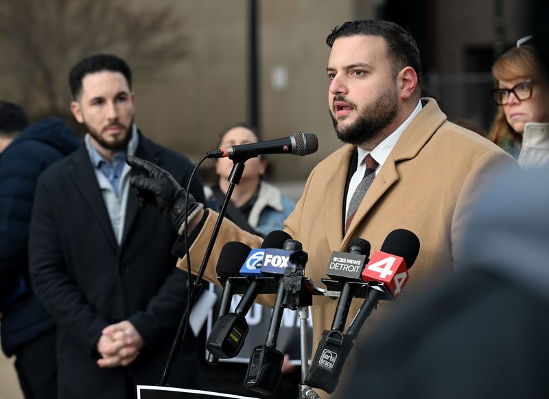 Dearborn Mayor Abdullah Hammoud, left, and others listen as State Rep. Alabas Farhat, D-Dearborn, urges Congress to rein in President Donald Trump's war on Iran during a press conference outside the McNamara Federal Building in Detroit on March 4, 2026.