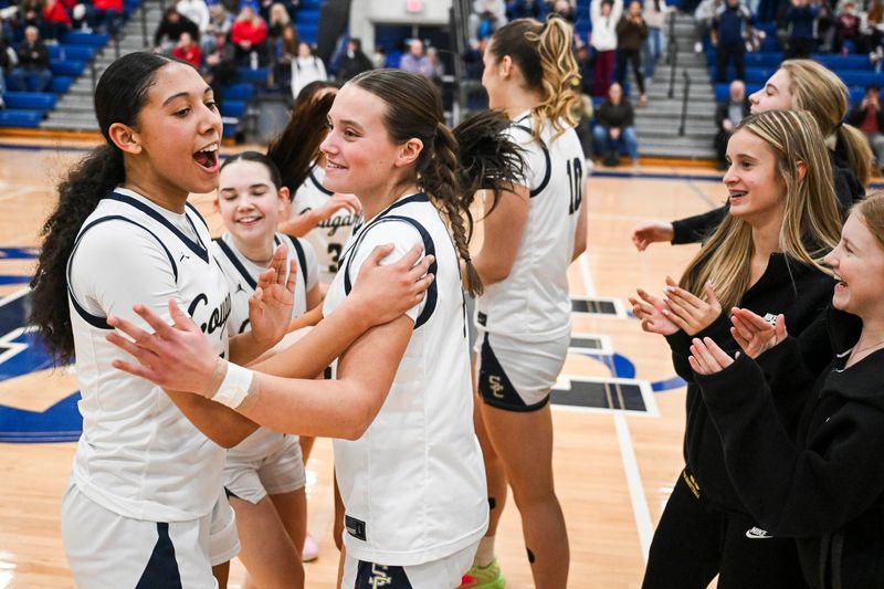 Stoney Creek’s Jadelynn Freeman, left, celebrates with teammates after their 49-45 Div. 1 district semifinal victory over Romeo on Wednesday, March 4, 2026 at Eisenhower High School in Shelby Township.
